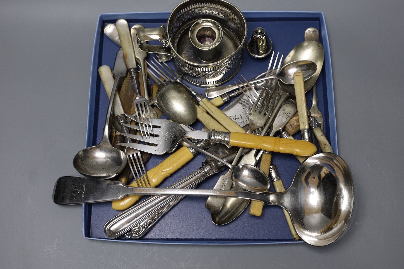 Mixed plated items including chamberstick, pair of fish servers, plated soup ladle and other flatware.